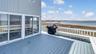 Deck with a view of the beach and a water view