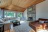 Living room with wood burning stove & sliders to side deck overlooking back yard