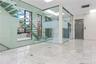 Unfurnished room featuring elevator, marble finish flooring, and a high ceiling