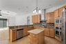 The spacious kitchen offers abundant cabinetry, generous workspace, and exceptional storage.