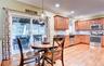 Kitchen with wood flooring, recessed lighting, and a sliding glass door opening to an enclosed porch