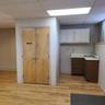 Kitchen featuring light countertops, a paneled ceiling, and light wood finished floors