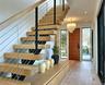 Stairs featuring wood walls, wood finished floors, visible vents, and a notable chandelier