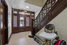 Entryway featuring dark wood-finish doors with glass inserts, transom windows, a decorative wood-finish staircase, and patterned wall panels