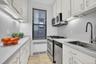 Abundant cabinet space with window and stainless steel appliances