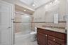 Newly Renovated Hallway Bathroom With Custom Tile and Soaking Tub