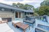 Wooden terrace featuring grilling area and an outdoor living space