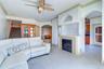 Family room with gas fireplace with the kitchen entry to the right and living area straight ahead