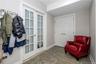 Mudroom w/ door to Garage and Door to playroom and bathroom and den / office.