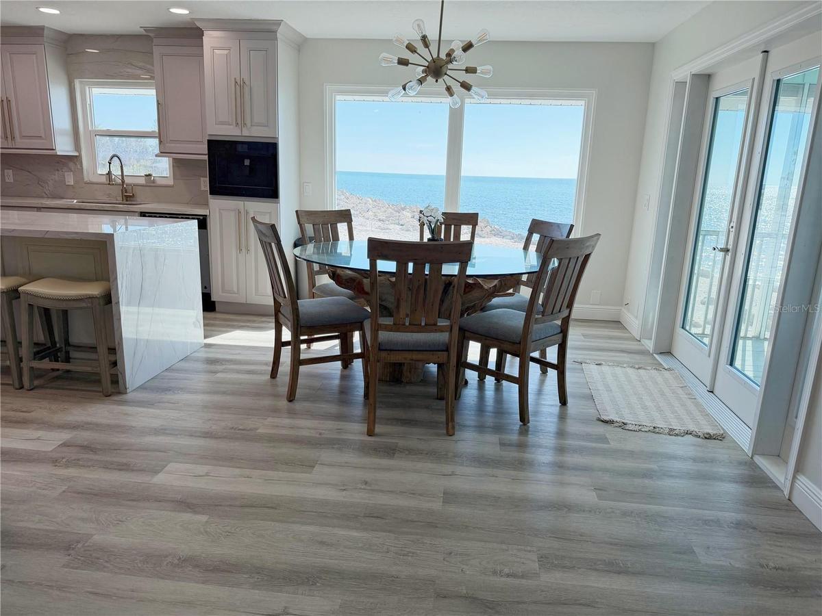 Dining area and kitchen with Gulf views and open floor plan.
