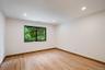 Room featuring a window with black trim, wood-finish flooring, recessed lighting, and crown molding