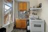 White walls with a window, stainless steel refrigerator, and stainless steel range