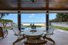 Covered patio pool deck with firepit and seating area