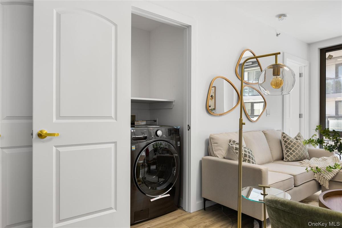 Laundry room featuring washer / dryer, laundry area, and light wood finished floors