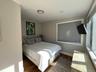 Bedroom featuring wood finished floors and baseboards