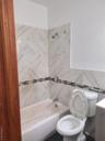 Full bath with toilet, vanity, and bathing tub / shower combination