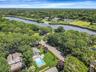 Drone / aerial view of a forest and a nearby body of water