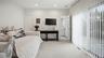 Bedroom with queen daybed, and sliding doors to yard & pool.