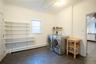 Washroom with laundry area, crown molding, baseboard heating, and washer and dryer