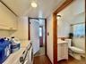 0 - Laundry area featuring a baseboard radiator, laundry area, dark wood finished floors, a sink, and washer and dryer