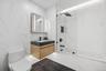 Bathroom with marble tiled floors, vanity, bathtub / shower combination, and toilet