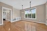 As you pass through the kitchen, a small hallway connects the primary suite, lavatory, and back entrance from the covered garage breezeway.