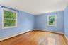 Unfurnished room featuring a baseboard heating unit, light wood finished floors, and ornamental molding