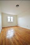 3rd Floor bedroom with light wood-style floors and ornamental molding