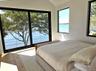 Bedroom featuring a water view and lofted ceiling