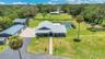 Aerial View of ADU, 6 car garage, Workshop (2 car space) and 2/1 guest unit with a loft and kitchenBrand new Hardie Board siding on ADU, metal roof o