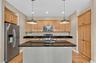 Abundant cabinetry, granite countertops, stainless steel appliances, and a central island for everyday function.