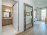 Retreat to the primary suite, complete with a luxurious en-suite bath showcasing a Siene wood vanity, marble countertops and marble flooring.