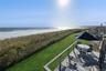 Water view featuring a fenced backyard and nearby beach