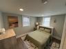 Bedroom with wood tiled floors, recessed lighting, and multiple windows