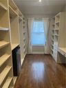 Another view of the Transformed 3rd bedroom that has shelving and a desk on both sides.