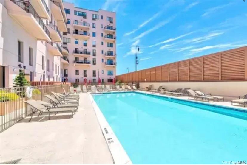 Community pool with a patio