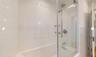 Bathroom featuring shower / bath combination with glass door