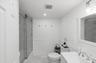 Bathroom featuring wainscoting, marble look tile flooring, vanity, combined bath / shower with glass door, and recessed lighting
