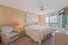 Primary bedroom with private waterfront balcony.