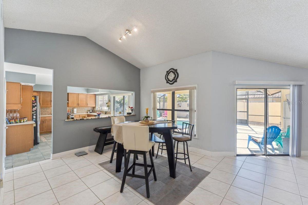View of dinette in great room with access to pool and kitchen