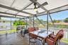 Large covered deck with stairs to pool.