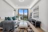 Living area featuring light wood-style flooring, baseboards, recessed lighting, and a raised ceiling