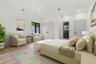 Vaulted ceiling bedroom with recessed lighting, light wood-finish flooring, and a large black-framed window