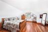 Bedroom with hardwood / wood-style flooring and lofted ceiling