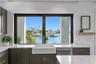 window sink in kitchen with water view