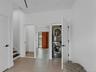 Entrance with washer/dryer, stairs to second floor, coat closet and half bath