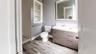 Bathroom featuring vanity, hardwood / wood-style floors, toilet, and walk in shower