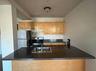 Kitchen with range, white refrigerator, and sink