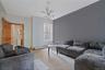 Living area featuring a modern Sputnik-style chandelier, a window with natural light, and a two-tone wall finish