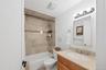 Bathroom featuring a vanity with a light-toned countertop, a rectangular undermount sink, and a chrome faucet